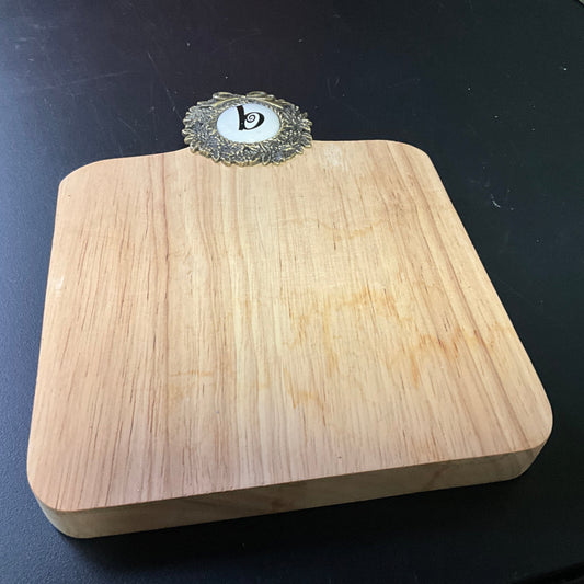Cute cutting board with beautiful brass wreath medallion embellished with a b cross stitch finishing button wall hanging
