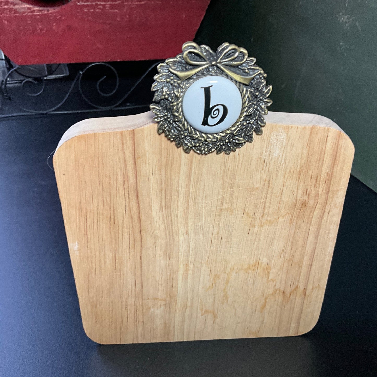 Cute cutting board with beautiful brass wreath medallion embellished with a b cross stitch finishing button wall hanging
