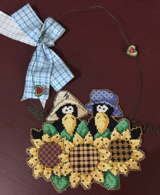 Ma and Pa Crows in the Sunflowers, stitched wall hanging embellished with little hearts and bow
