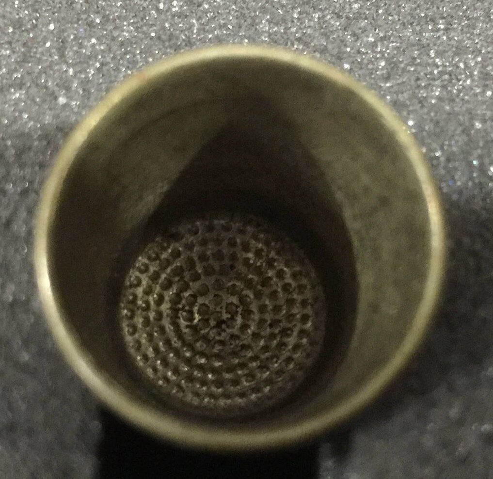 Vintage Collectible thimble has the number 10 and an interesting pattern and the bottom engraved into it