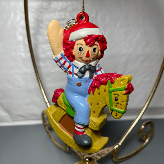 Raggedy Andy In Santa Cap Riding A Rocking Horse Christmas Tree Ornament