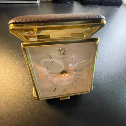 Westclox mechanical wind up travel alarm clock in gold-tone numbers and trim in dark brown case vintage collectible keepsake