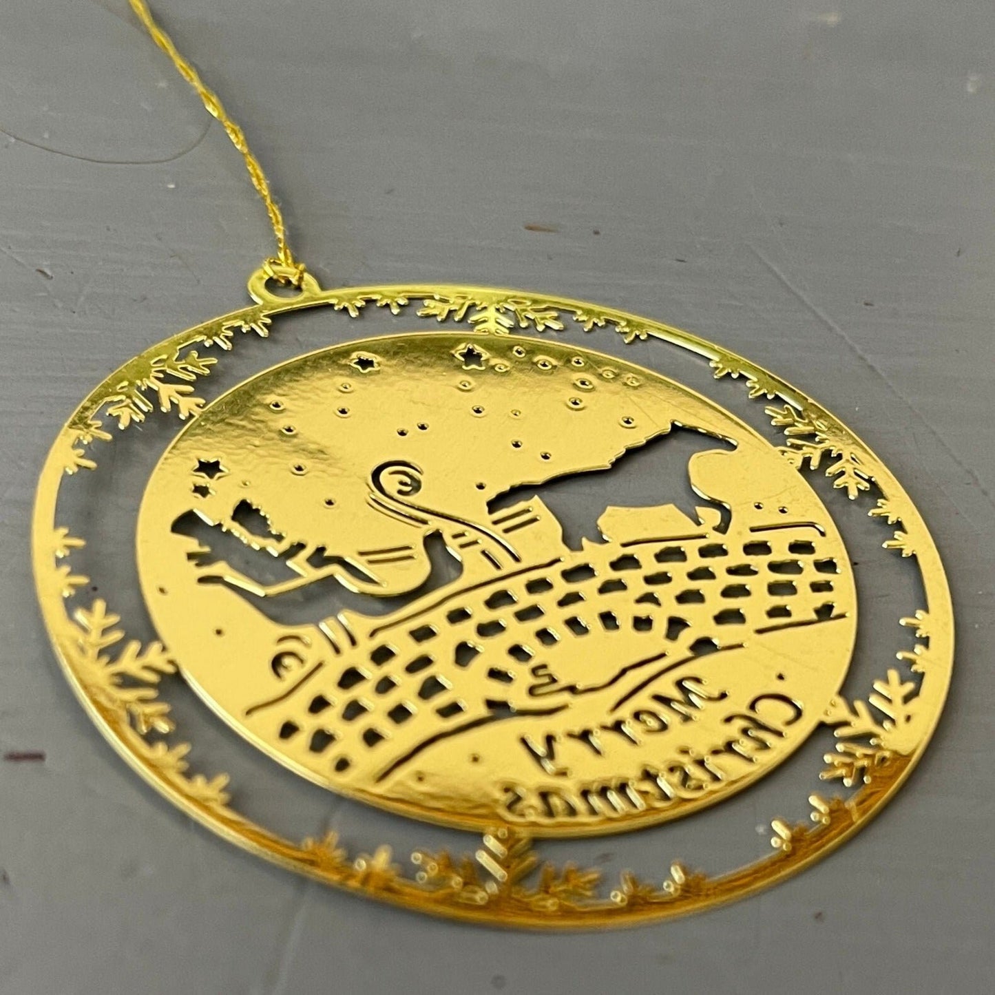 Horse drawn sleigh on an old stone bridge Merry Christmas 2 inch round gold-tone metal ornament