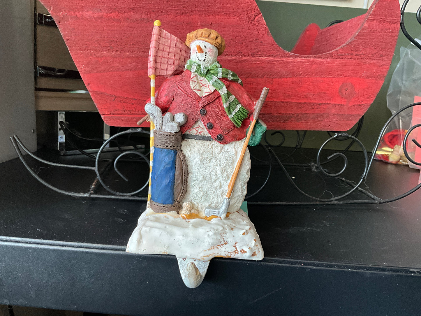 Golf player snowman cast iron manual stocking hanger