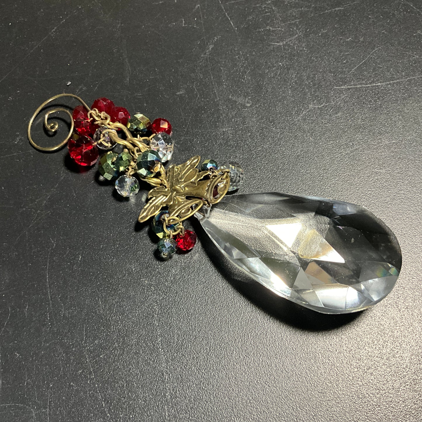 Charming crystal teardrop with gold-tone bell medallion and red & clear crystal berries fancy swirl hook ornament