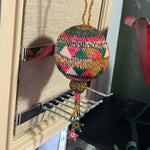 Beautiful handmade beaded round ornament with hanging star tassels
