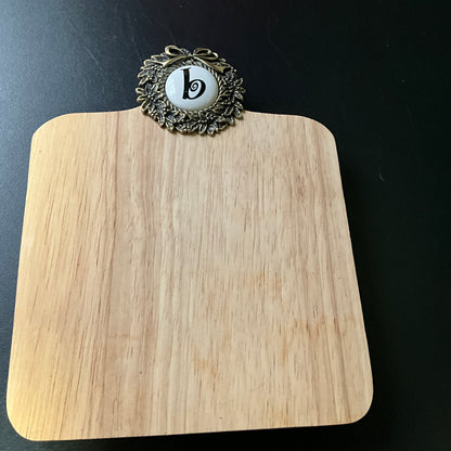 Cute cutting board with beautiful brass wreath medallion embellished with a b cross stitch finishing button wall hanging