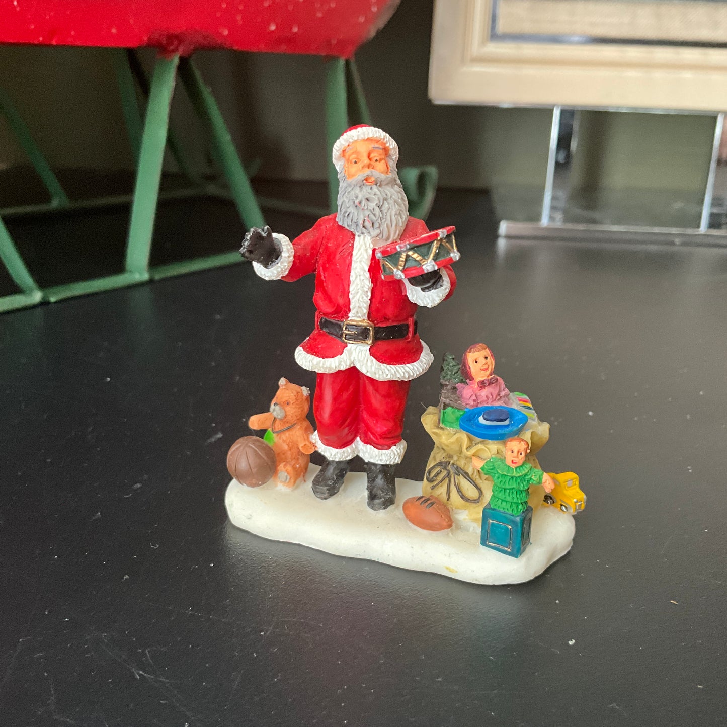 Lemax Santa Claus holding a little toy drum next to his sack of toys collectible figurine