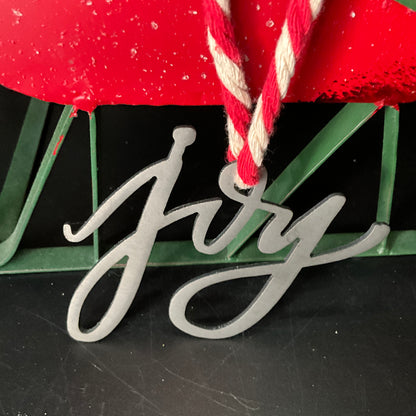 JOY lazer cut steel cutout Christmas ornament on a rope