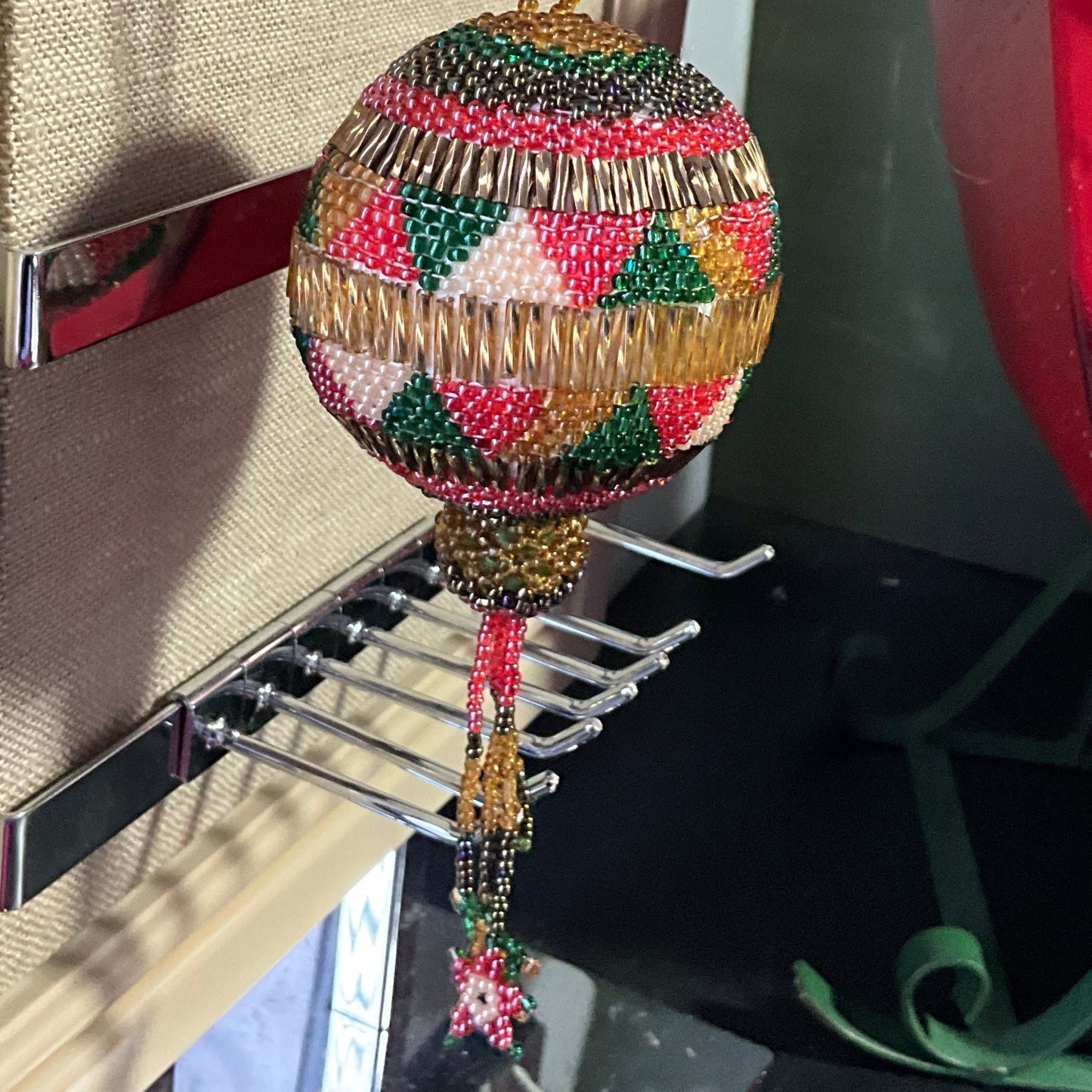 Beautiful handmade beaded round ornament with hanging star tassels