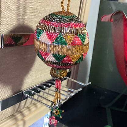 Beautiful handmade beaded round ornament with hanging star tassels