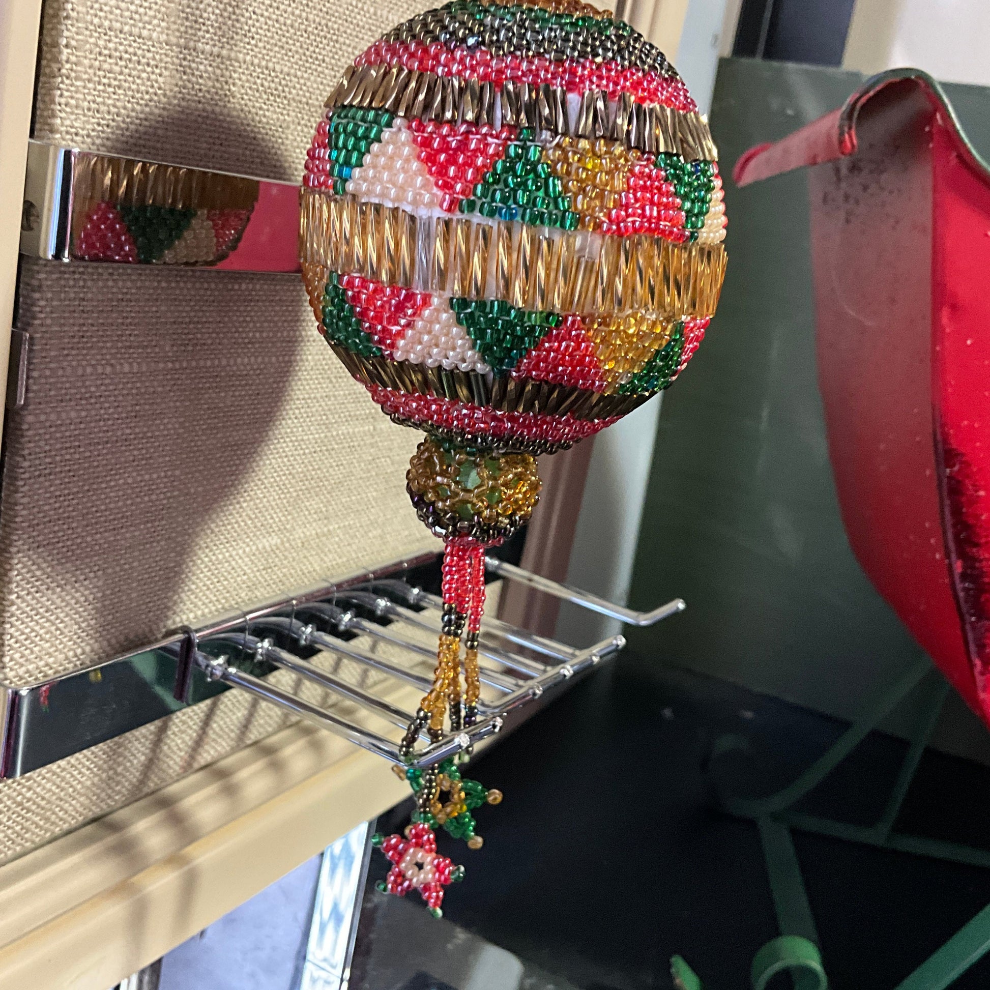 Beautiful handmade beaded round ornament with hanging star tassels