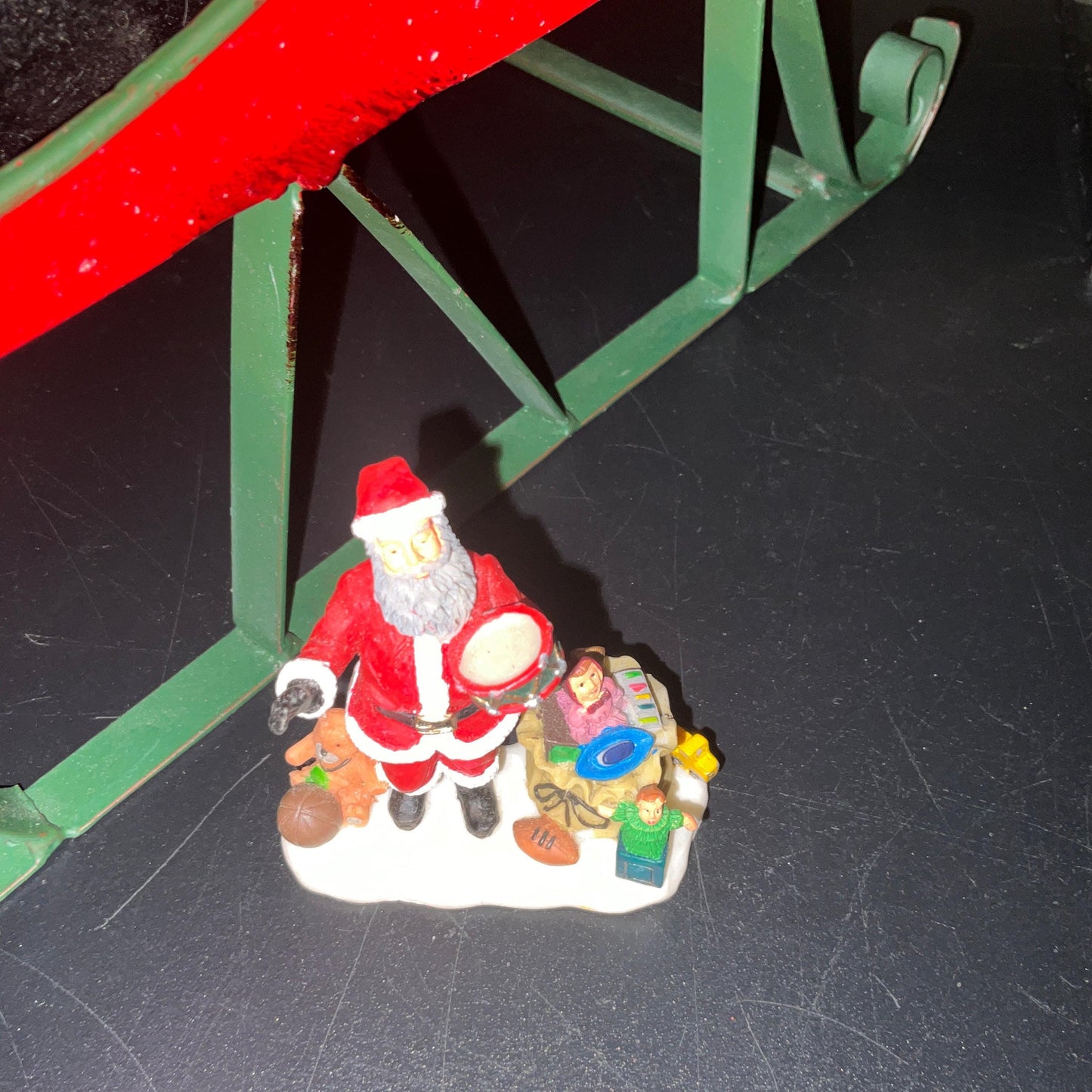 Lemax Santa Claus holding a little toy drum next to his sack of toys collectible figurine