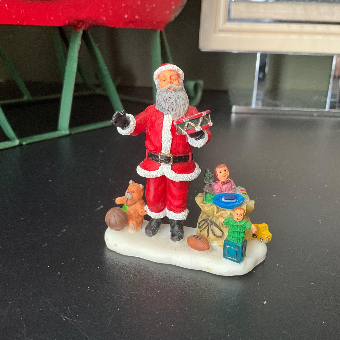 Lemax Santa Claus holding a little toy drum next to his sack of toys collectible figurine