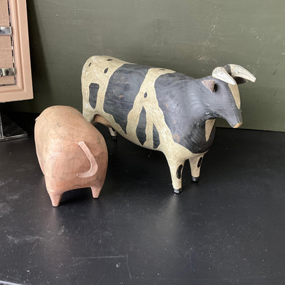 Colossal cow and pig large carved wood animals with leather tails set of 2 figurines