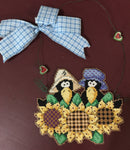 Ma and Pa Crows in the Sunflowers, stitched wall hanging embellished with little hearts and bow