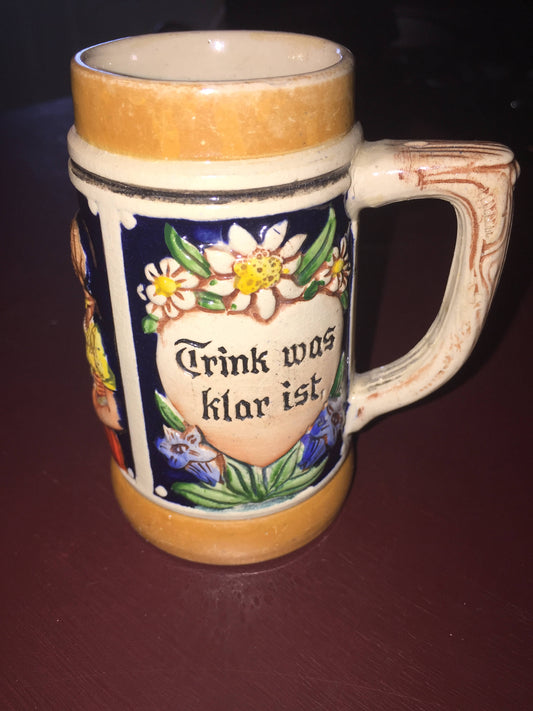Small Beer Stein depicting couple drinking with the words Trink was klar ist (drink what is clear) Lieb was rar ist (loving what is scarce)