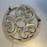 Ornate 7.5 inch round  cast aluminum trivet vintage kitchen tool
