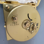 Westclox mechanical wind up travel alarm clock in gold-tone numbers and trim in dark brown case vintage collectible keepsake